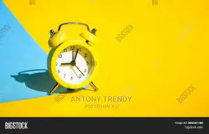 Yellow Vintage Alarm Clock on a Blue and Yellow Background
