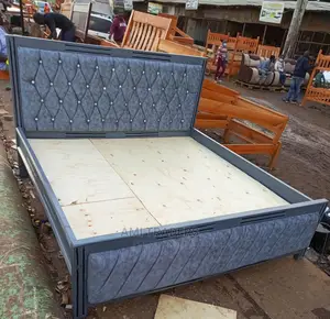 Grey Tufted Bed.