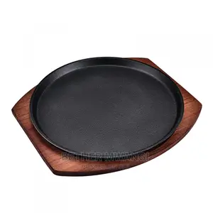 Cast-Iron Hot Sizzling Plate on Wooden Tray in Kenya