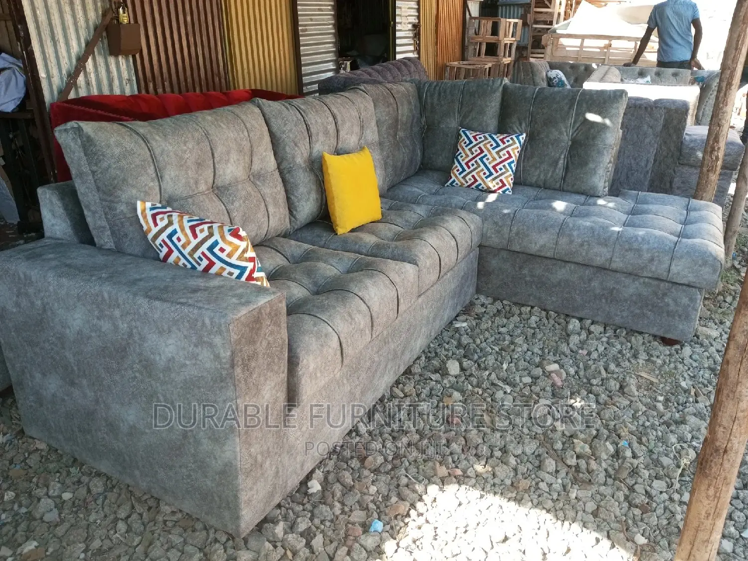 L Shaped Sofa a Table and 2 Throw Pillow