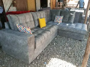 L Shaped Sofa a Table and 2 Throw Pillow