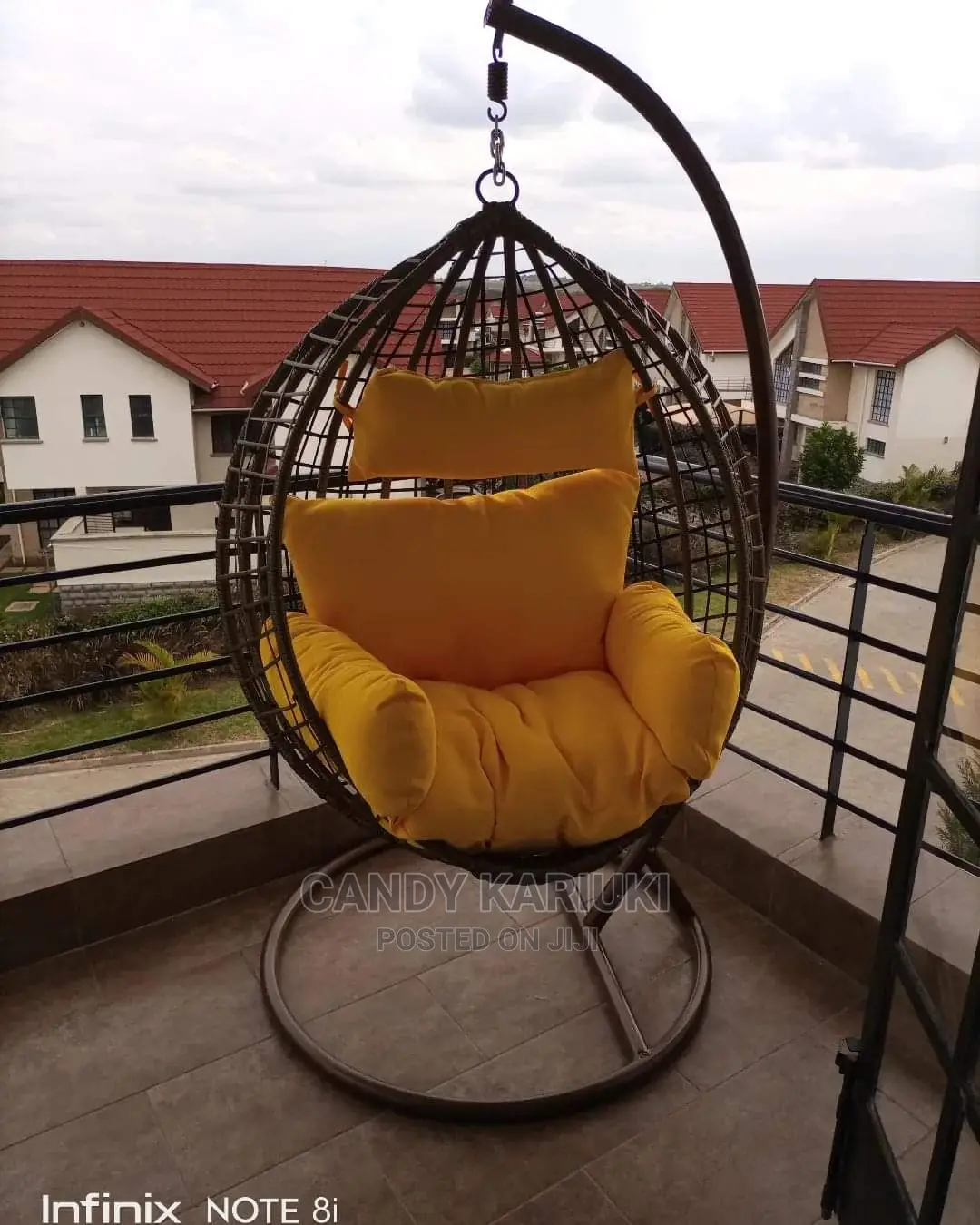 Balcony Swing With Yellow Cushions