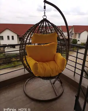 Balcony Swing With Yellow Cushions