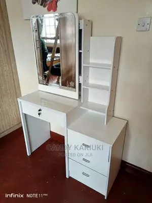 White Dresser With a Sliding Mirror