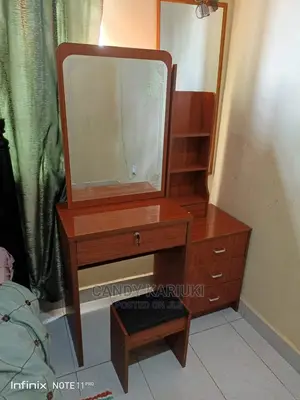 Brown Dresser With a Sliding Mirror