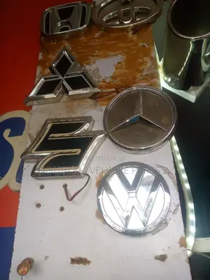 Emblem Logo Suzuki and Other Assorted Vehicles