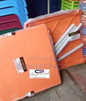 Orange Plastic Table With Metallic Legs.