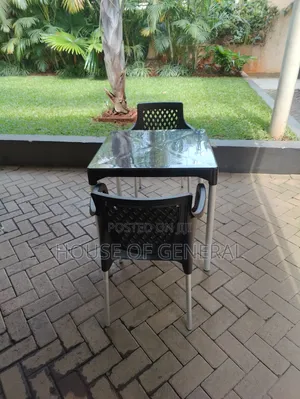 Black 2 Plastic Chairs and 1 Plastic Table
