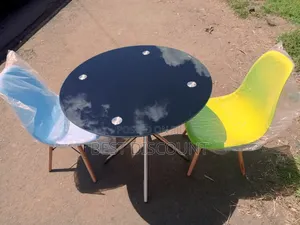Black Table and Multi - Colored Chairs