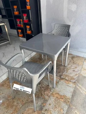 2 Plastic Chair With Metal Tubing and 1 Plastic Table