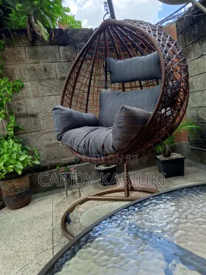 Brown Outdoor Swing With Checked Cushions
