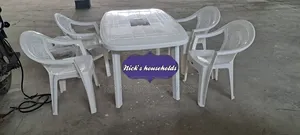 A Rectangular Plastic Table With 4 Plastic Chairs