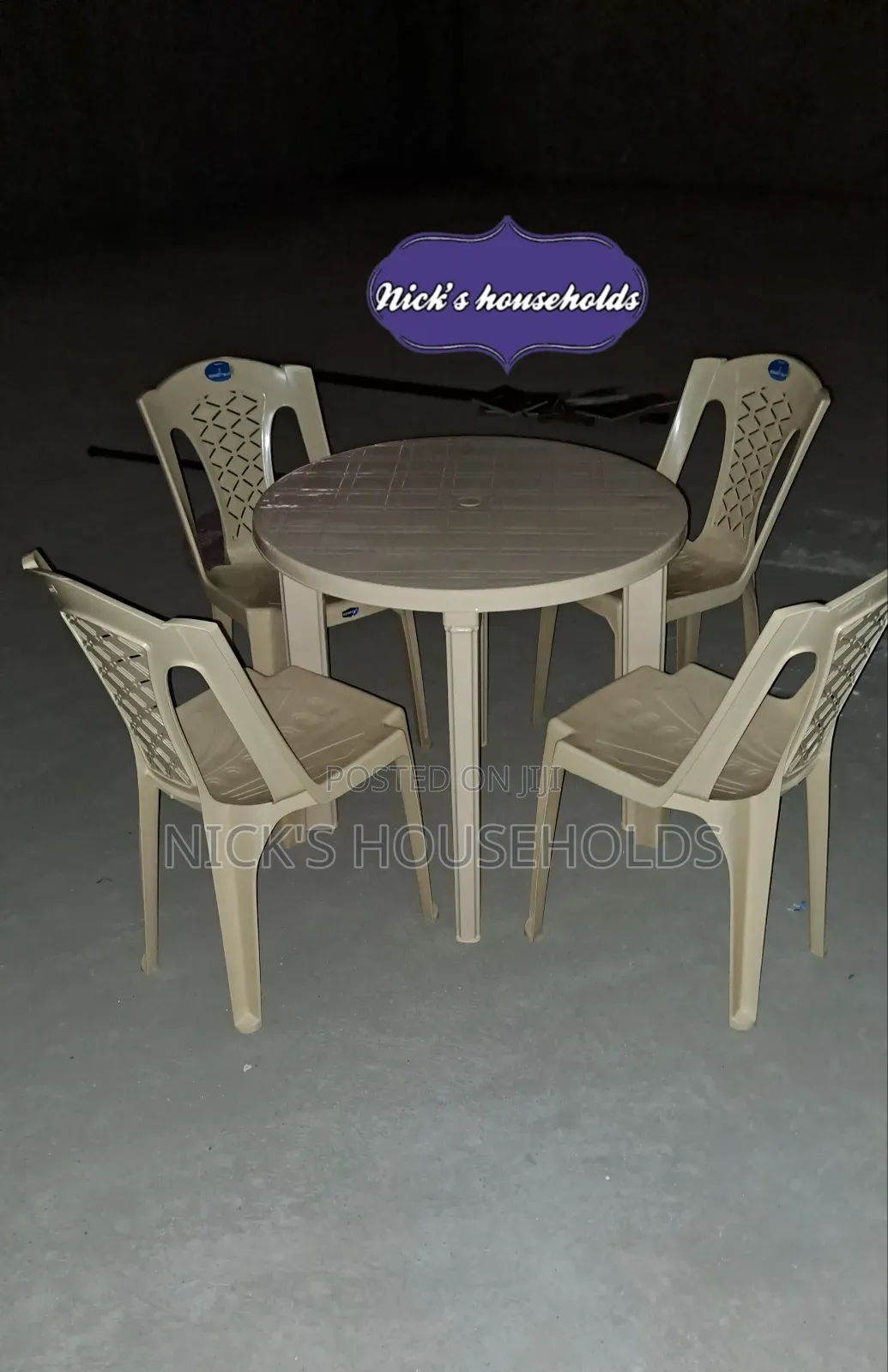 Cream Plastic Chairs With a Round Plastic Table Set