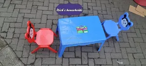 Red and Blue Plastic Chairs With a Plastic Table