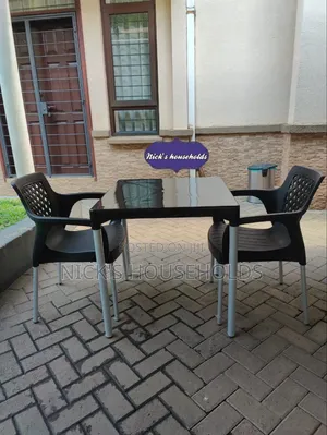 A Square Plastic Table With Plastic Chairs With Metal Legs