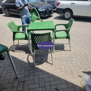 4 Green Plastic Chairs With a Square Plastic Table Set