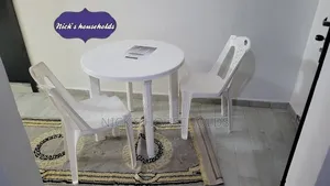 White Armless Chairs With a Complast Plastic Table Set