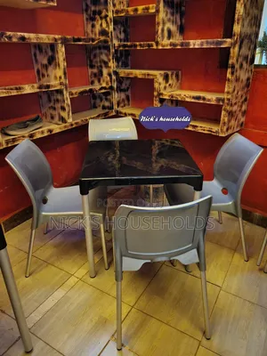 Complast Armless Plastic Chairs With a Square Plastic Table