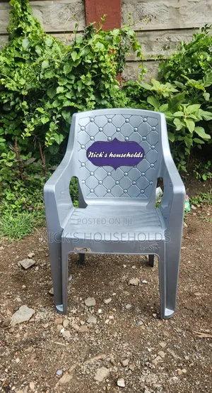 Gray Plastic Chair With High Arms And Pattern Backrest