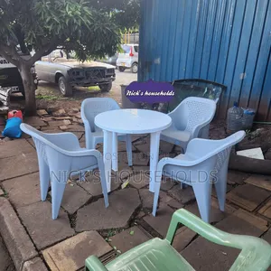 White Round Plastic Table With Gray Plastic Chairs Set