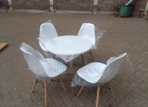 Round Dining Table With Four White Chairs