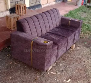 Brown Sofa With Cup Holders and Gold Accents