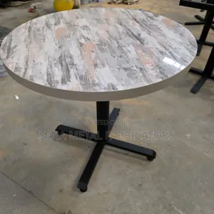 Glossy Restaurant Table, Circular With Sleek Metal Legs.