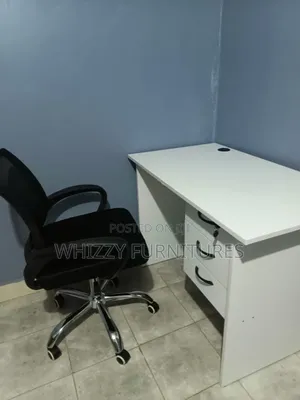 White Office Desk With a Black Ergonomic Office Chair