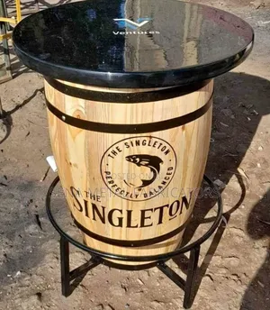 Barrel Bar Table With Logo and a Black Marble Top.