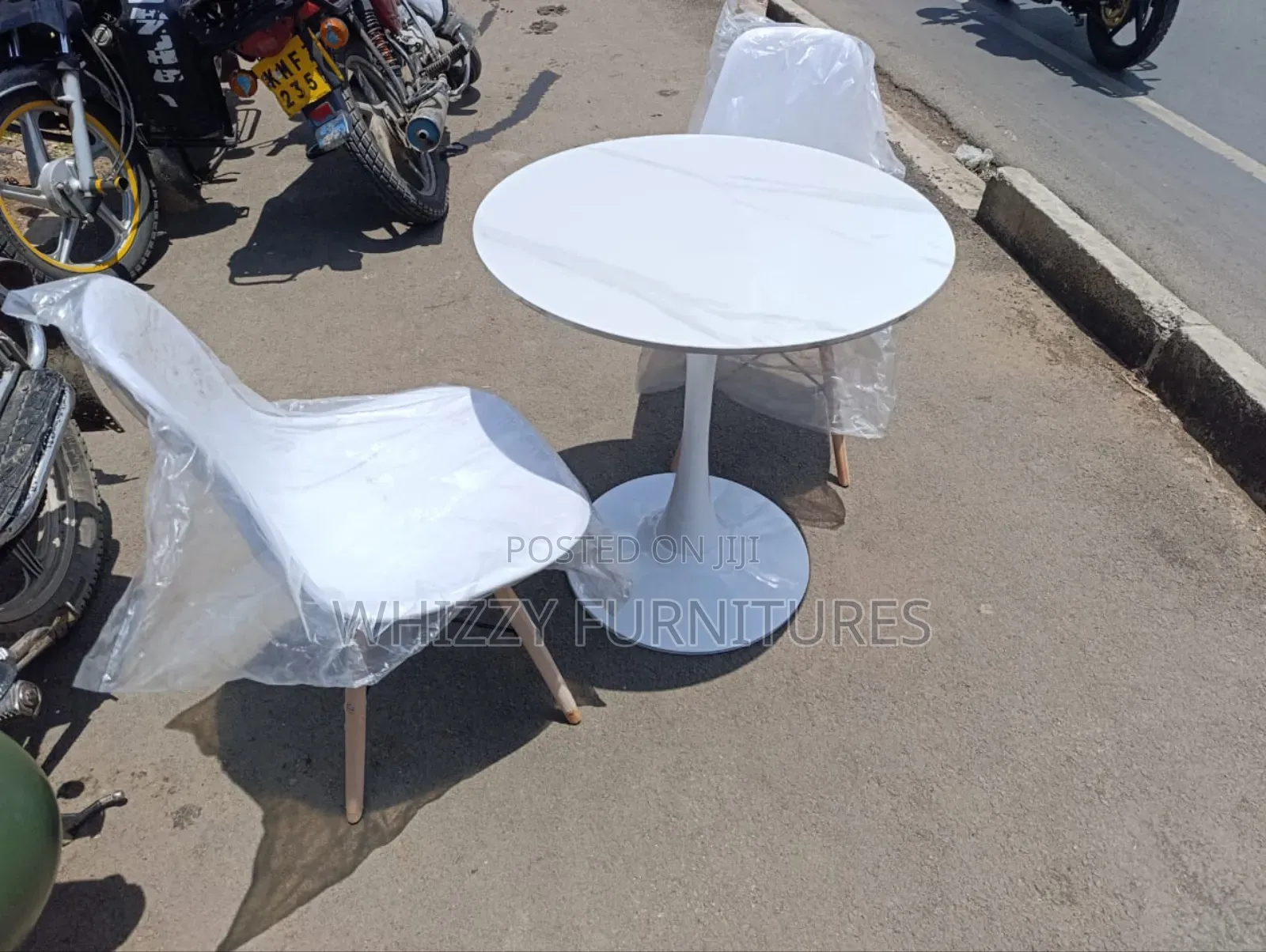 Dining Table With White Marble-Effect Top and White Eames-Style Chairs