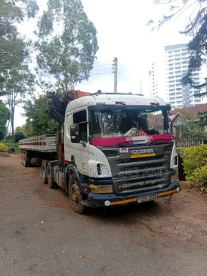 Flatbed Trailer With Crane Available for Transport Services