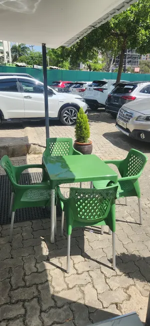 1 Plastic Table With 4 Plastic Chairs With Metal Tubing Legs Set