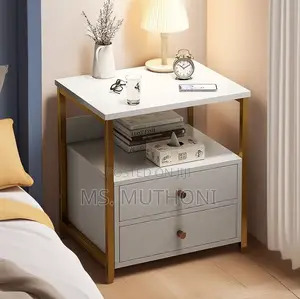 Two -Drawer Nightstand With a White Finish and Gold-Colored Frame.