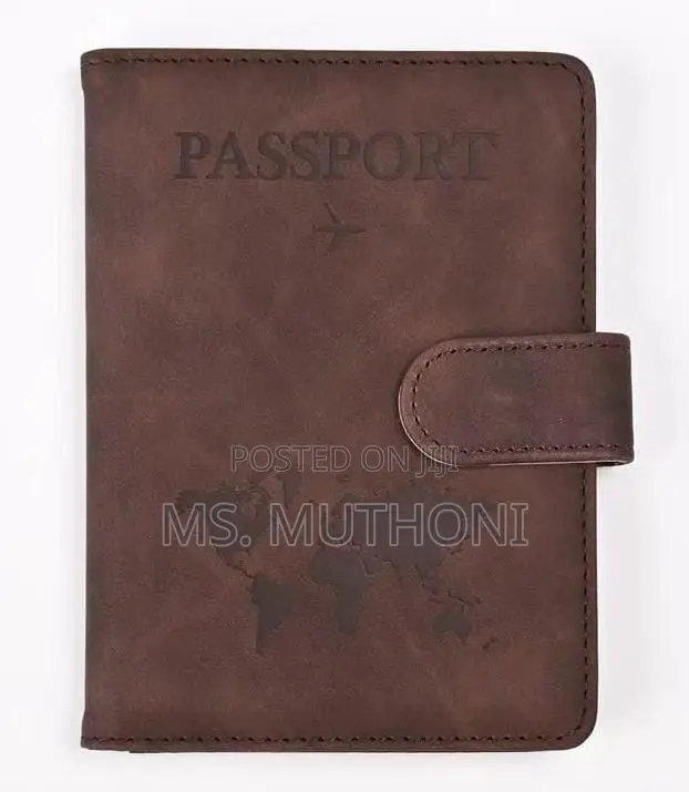 Passport Holder With a World Map Design and a Snap Closure.