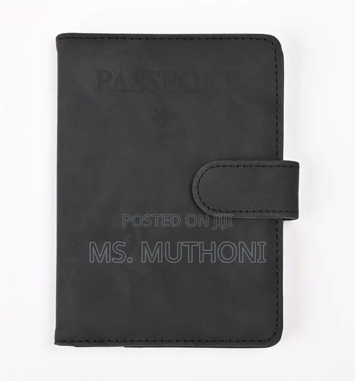 Passport Holder With a World Map Design and a Snap Closure.