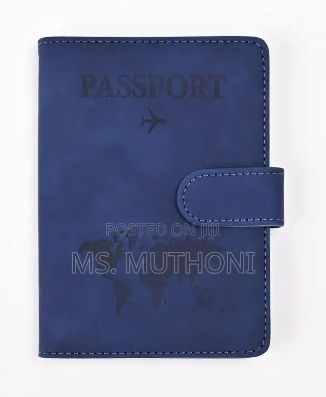 Passport Holder With a World Map Design and a Snap Closure.