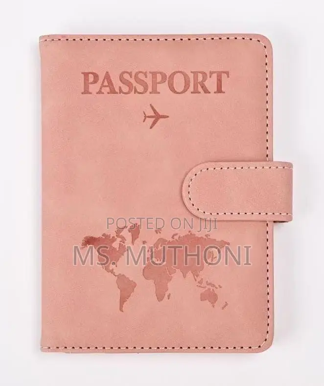 Passport Holder With a World Map Design and a Snap Closure.