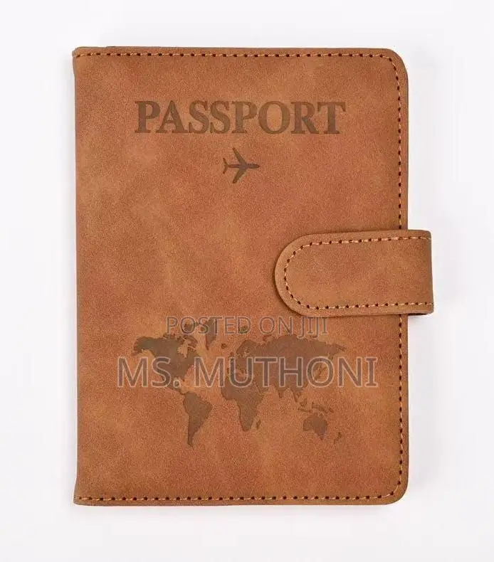 Passport Holder With a World Map Design and a Snap Closure.