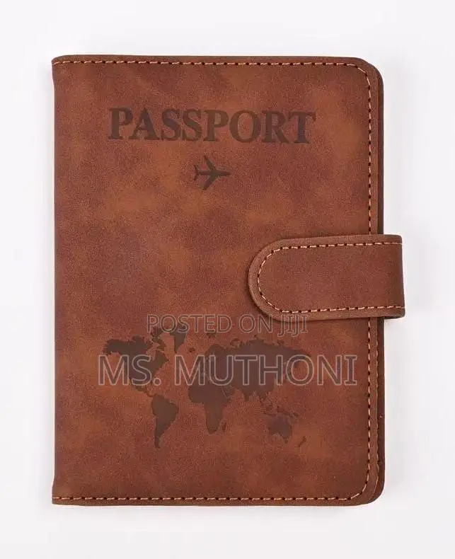 Passport Holder With a World Map Design and a Snap Closure.