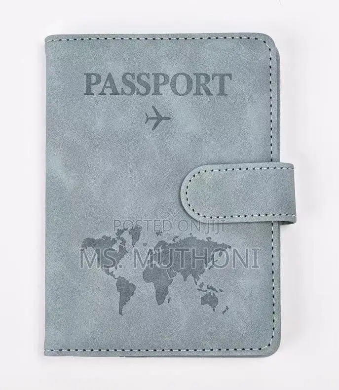 Passport Holder With a World Map Design and a Snap Closure.