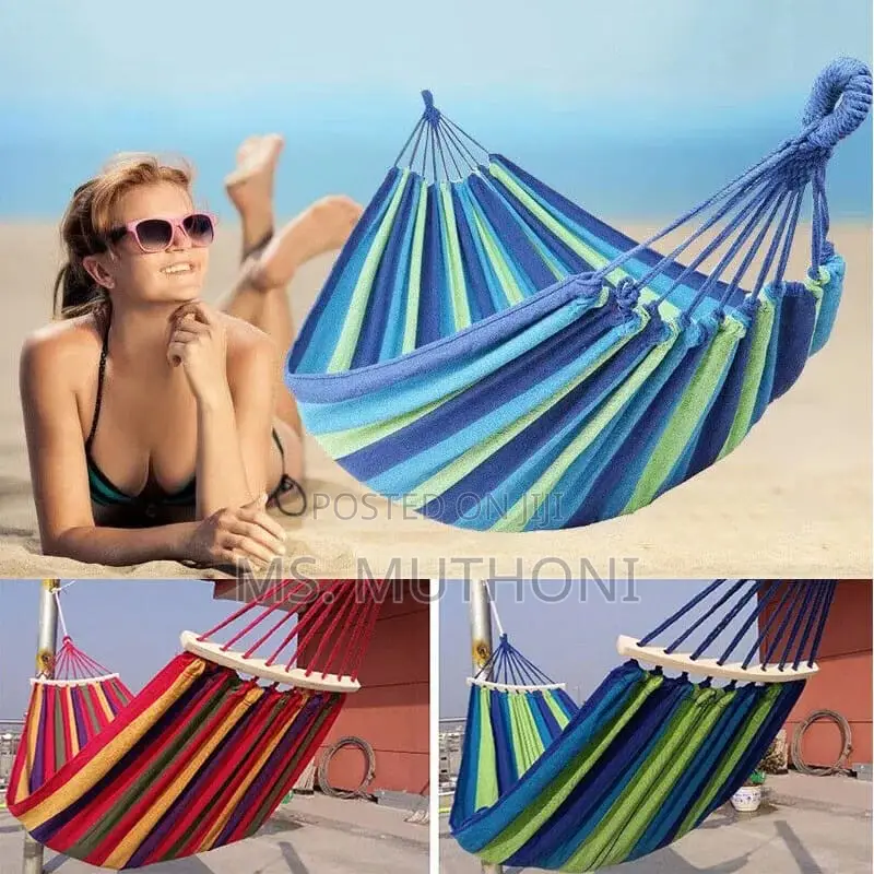 Blue and Green Striped Canvas Hammock With Spreader Bars.