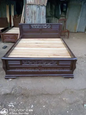 Dark Wood Bed With Carved Panels