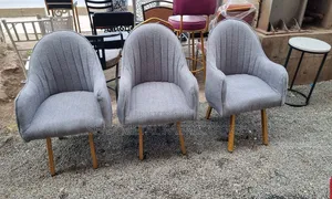 Modern Grey Upholstered Chair With Gold Base.