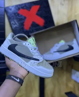 Nike Air Jordan 1 Low Travis Scott in the Dark Mocha Colorway.