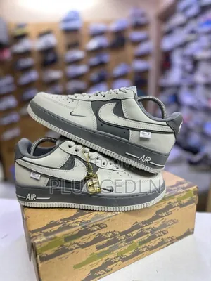 Nike Air Force 1 Low Sneakers in a Grey and Off-White Colorway.