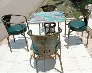 Dining Set With Antique Gold Metal Frame and Green Leather Fabric.