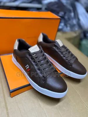 Brown Leather Sneaker With A White Sole And An "Rv" Logo.