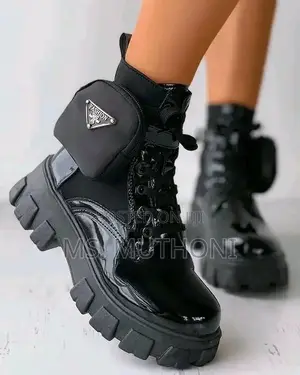 Black Patent Leather Prada Monolith Boots With a Detachable Pouch.
