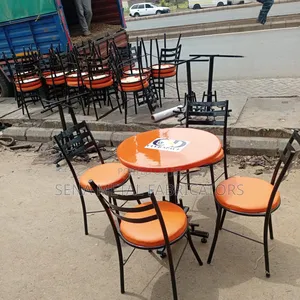 Branded Restaurant/Hotel Table With Orange Chairs.