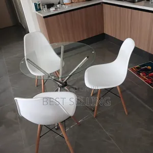 Colorless Top Glass Coffee Table With Eams Chair